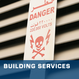 “Danger 220,000 Volts” warning sign in front of slatted background